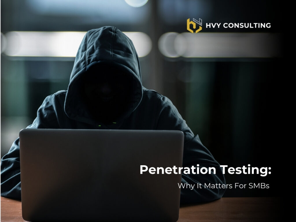 A man in a hoodie dressed like a hacker using a laptop doing penetration testing